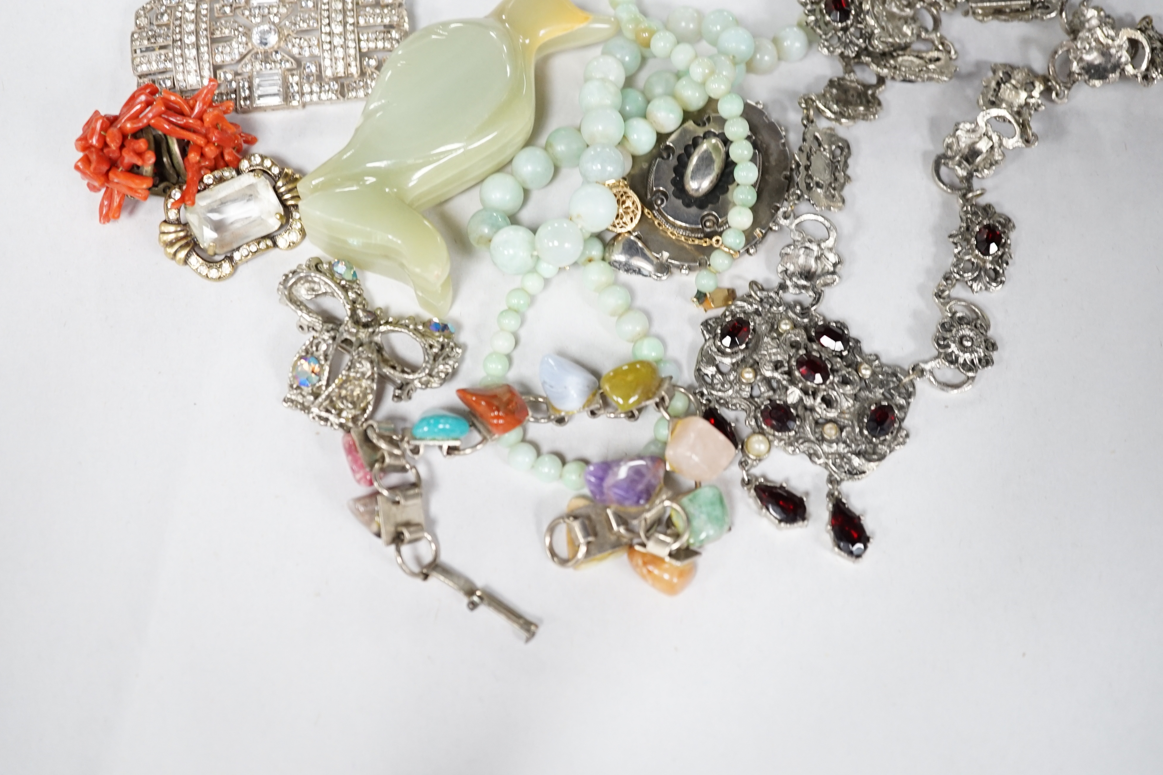 A quantity of assorted jewellery including necklaces, paste set costume, a Victorian white metal locket, hardstone bracelet etc. Condition - poor to fair